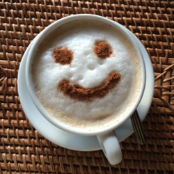 Coffee with foam with a cocoa smiley face