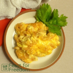 Baked macaroni and cheese on a plate garnished with parsley