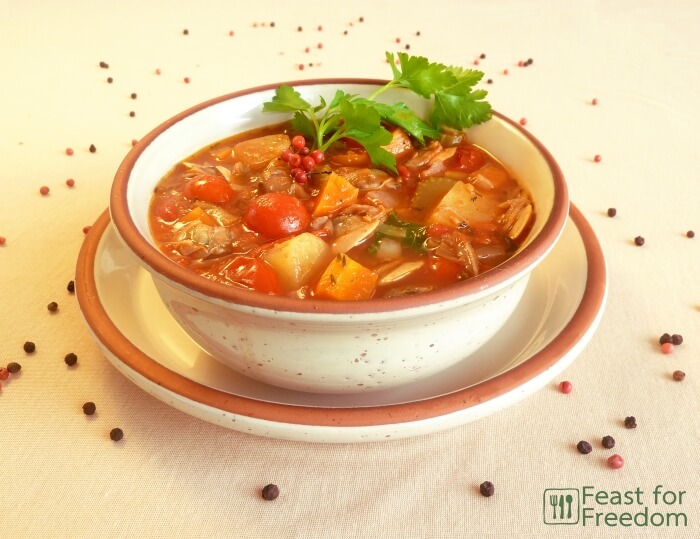 Manhattan tomato based clam chowder in a bowl garnished with parsley