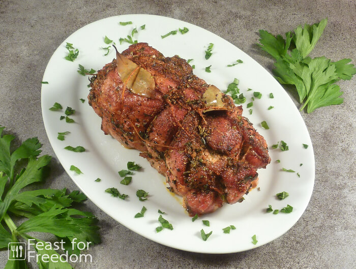 Pork Roast stuffed with fresh herbs on a serving platter