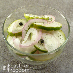 A small bowl of cucumber and onion refrigerator pickles