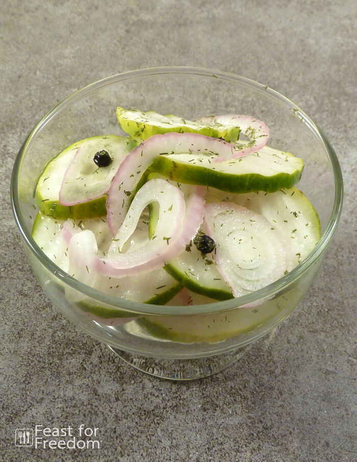 A small bowl of cucumber and onion refrigerator pickles