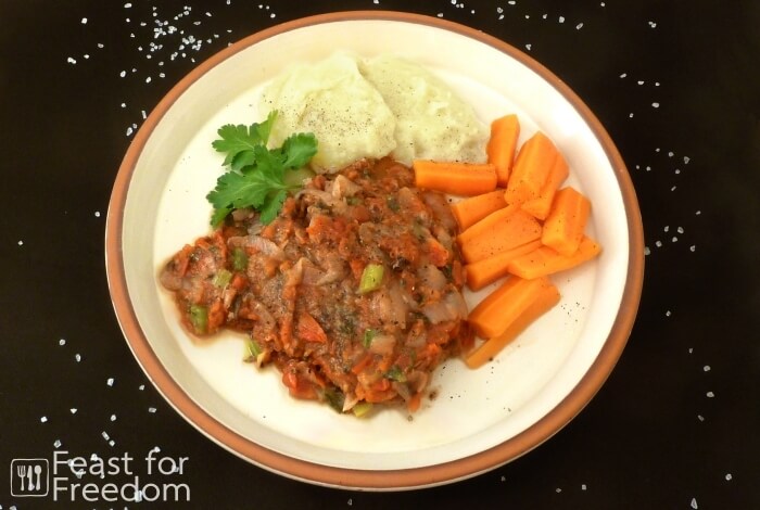 Braised beef with tomatoes, served with mashed potatoes and carrots